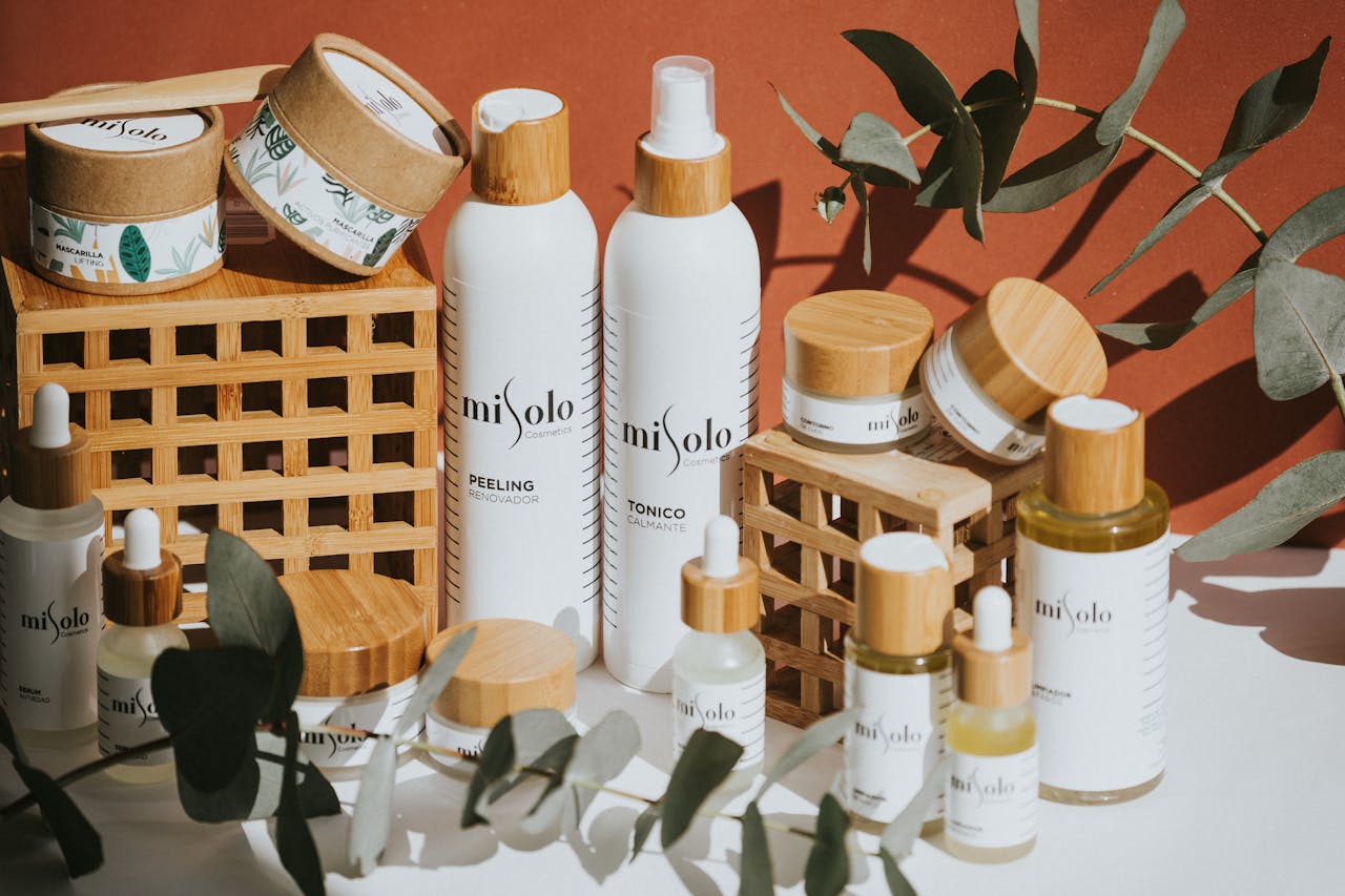 services-04 Aesthetic display of eco-friendly cosmetic products featuring eucalyptus leaves and bamboo elements.