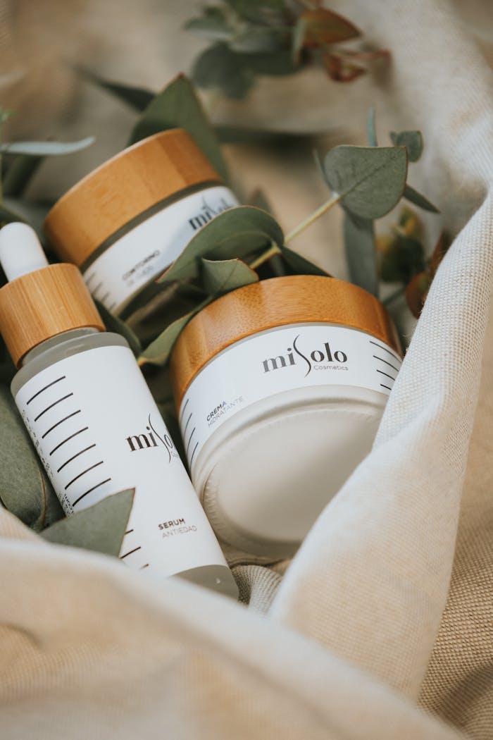 who-we-are Close-up of natural skincare products with wooden caps among linen fabric and leaves.