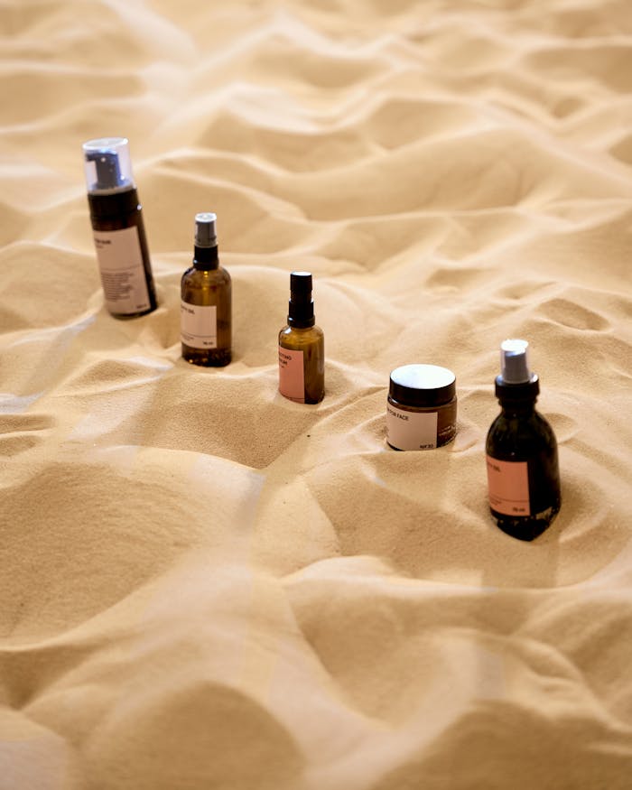 our-story Explore a unique arrangement of beauty products on a textured sand surface, offering a natural aesthetic.